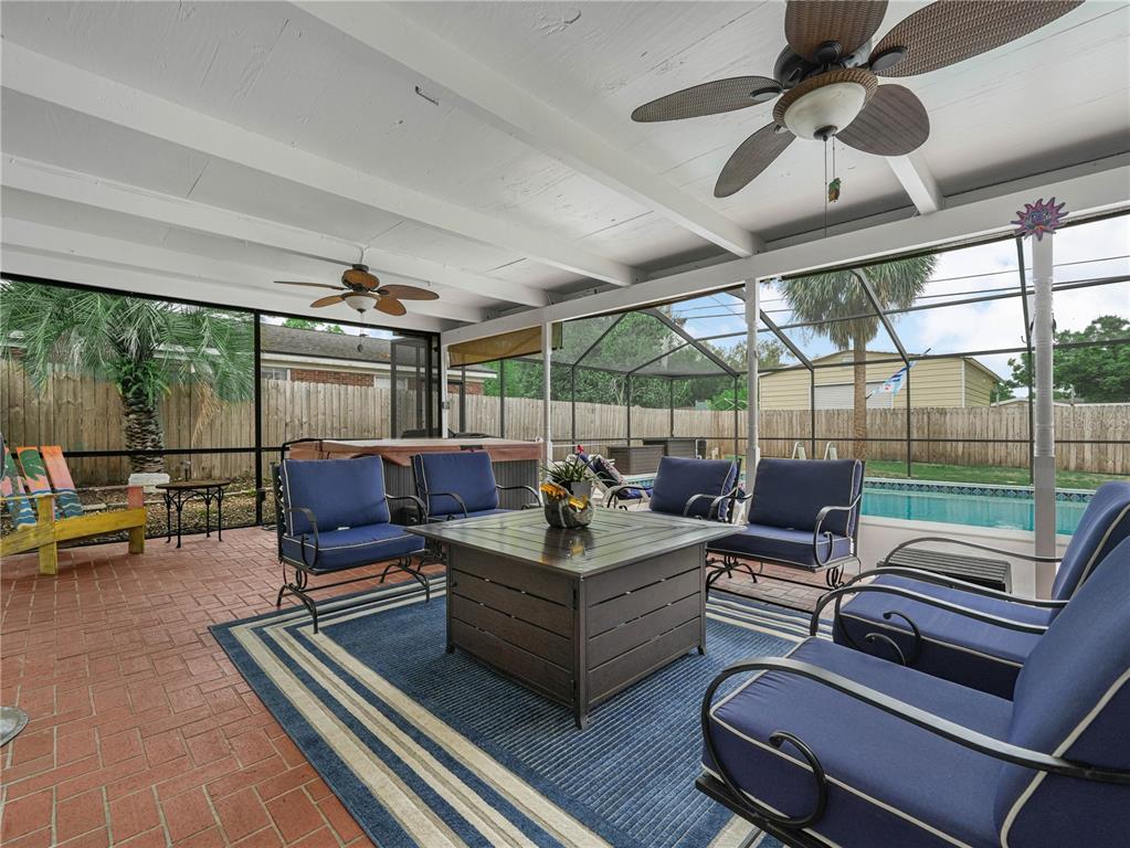 4615 Kings Point Court Lakeland, FL 33813 - Photo 31 of 41 a living room with furniture a rug and a floor to ceiling window