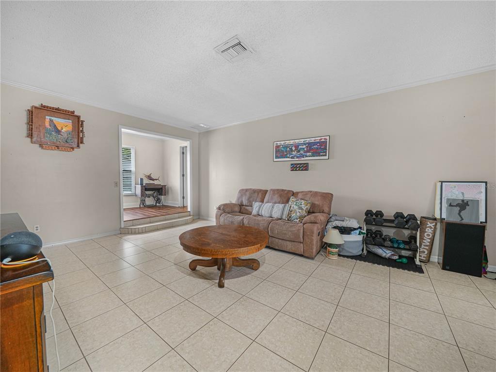 4615 Kings Point Court Lakeland, FL 33813 - Photo 4 of 41 a living room with furniture and a table