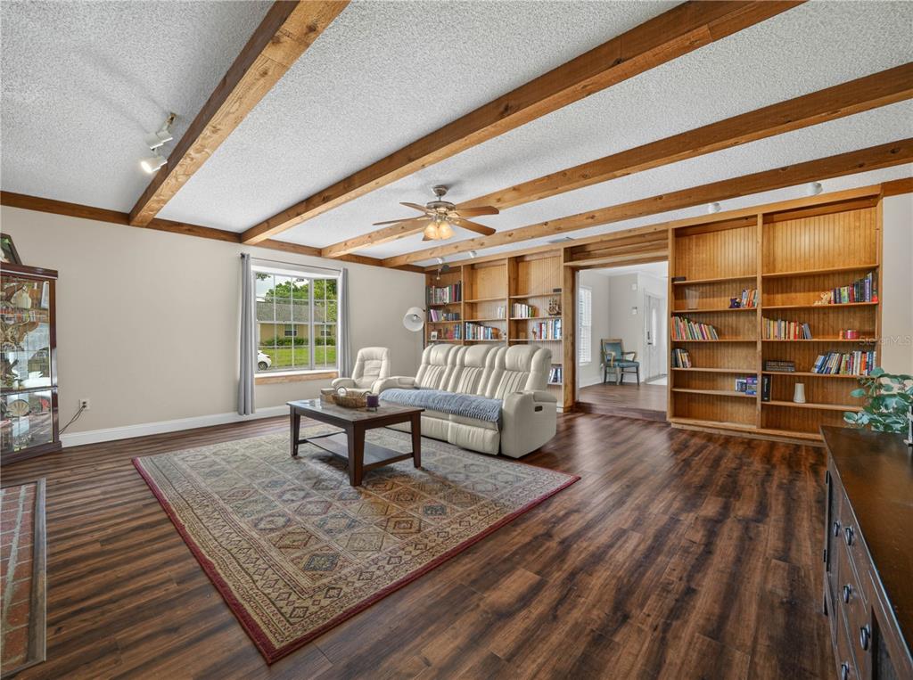 4615 Kings Point Court Lakeland, FL 33813 - Photo 7 of 41 a living room with furniture and a wooden floor