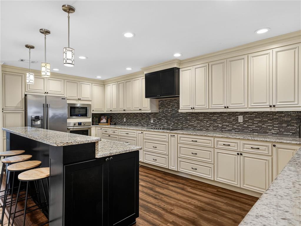 4615 Kings Point Court Lakeland, FL 33813 - Photo 10 of 41 a kitchen with stainless steel appliances granite countertop a sink and microwave