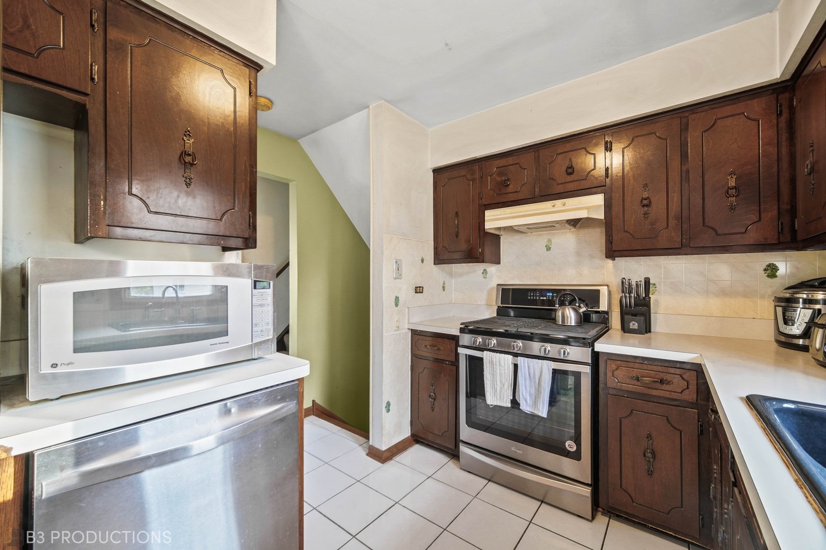15548 Long Avenue Oak Forest, IL 60452 - Photo 3 of 15 a kitchen with stainless steel appliances granite countertop a stove a microwave and a refrigerator