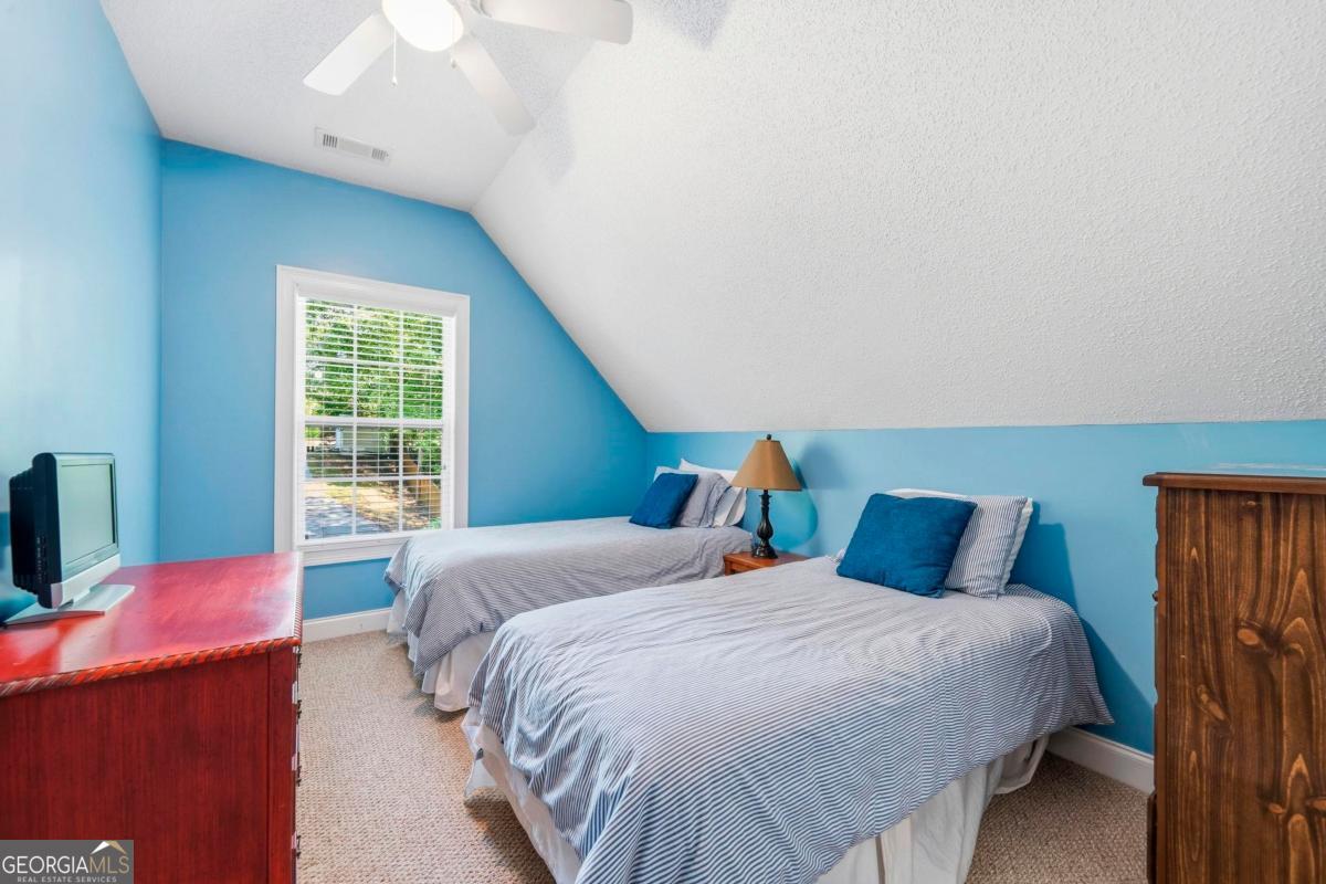 172 Mays Road Milledgeville, GA 31061 - Photo 38 of 54 a bedroom with a bed and wooden floor