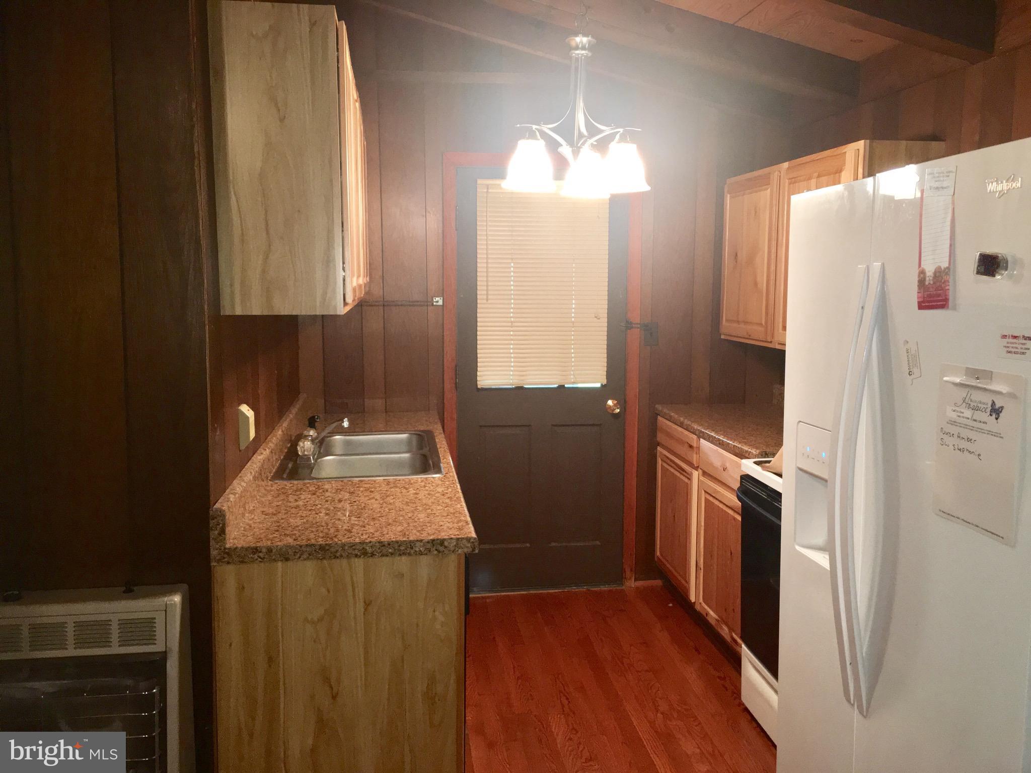 3609 Howellsville Road Front Royal, VA 22630 - Photo 7 of 18 a kitchen with granite countertop a refrigerator a sink and dishwasher
