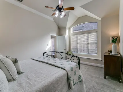 a bedroom with a bed dresser and a window