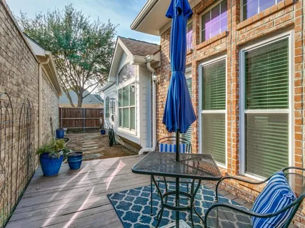 a view of a house with a chairs in patio