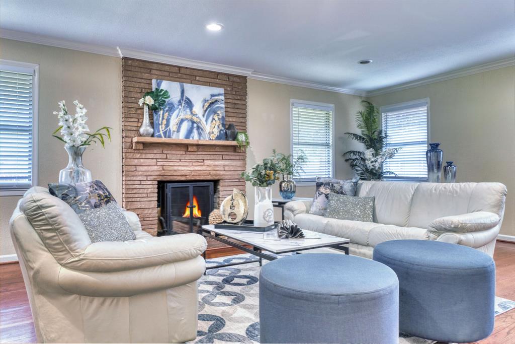 314 Easton Road Dallas, TX 75218 - Photo 18 of 26 a living room with furniture a fireplace and a large window