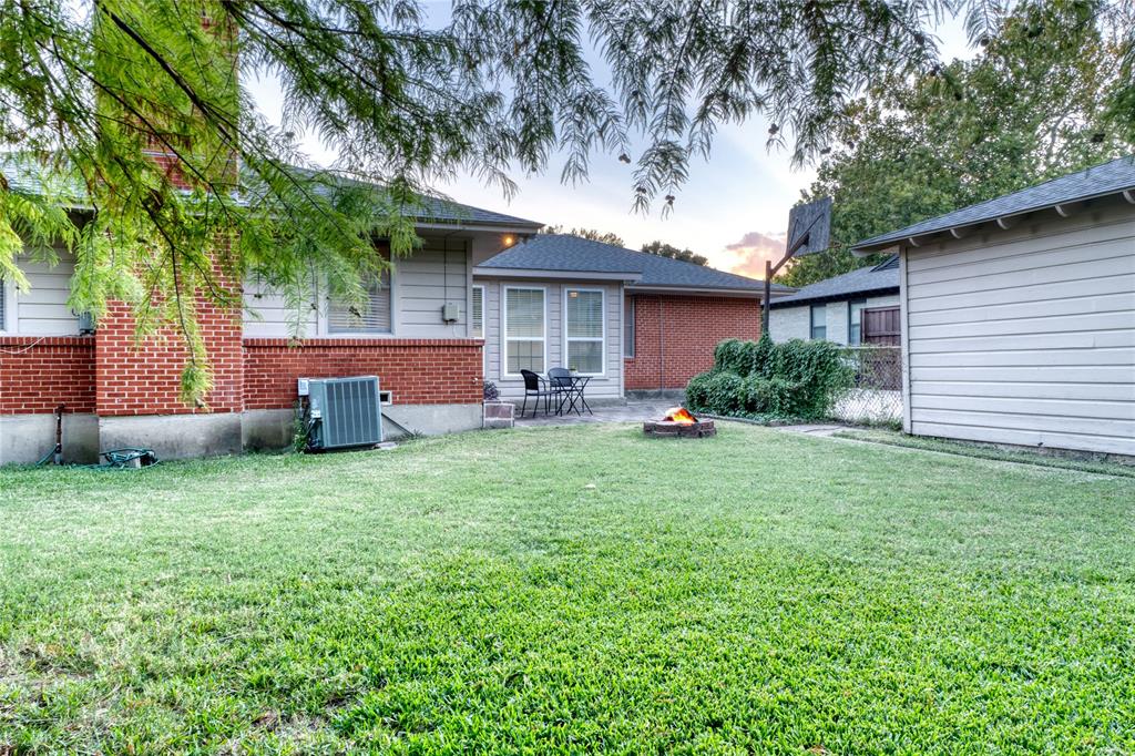 314 Easton Road Dallas, TX 75218 - Photo 24 of 26 a front view of a house with a garden
