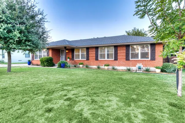 a front view of house with yard and green space