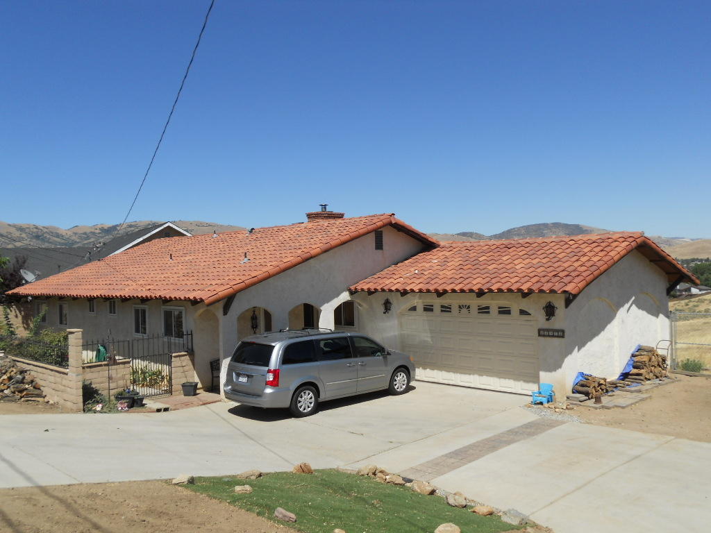 22712 Mariposa Road Tehachapi, CA 93561 - Photo 1 of 21 a car parked in front of a house