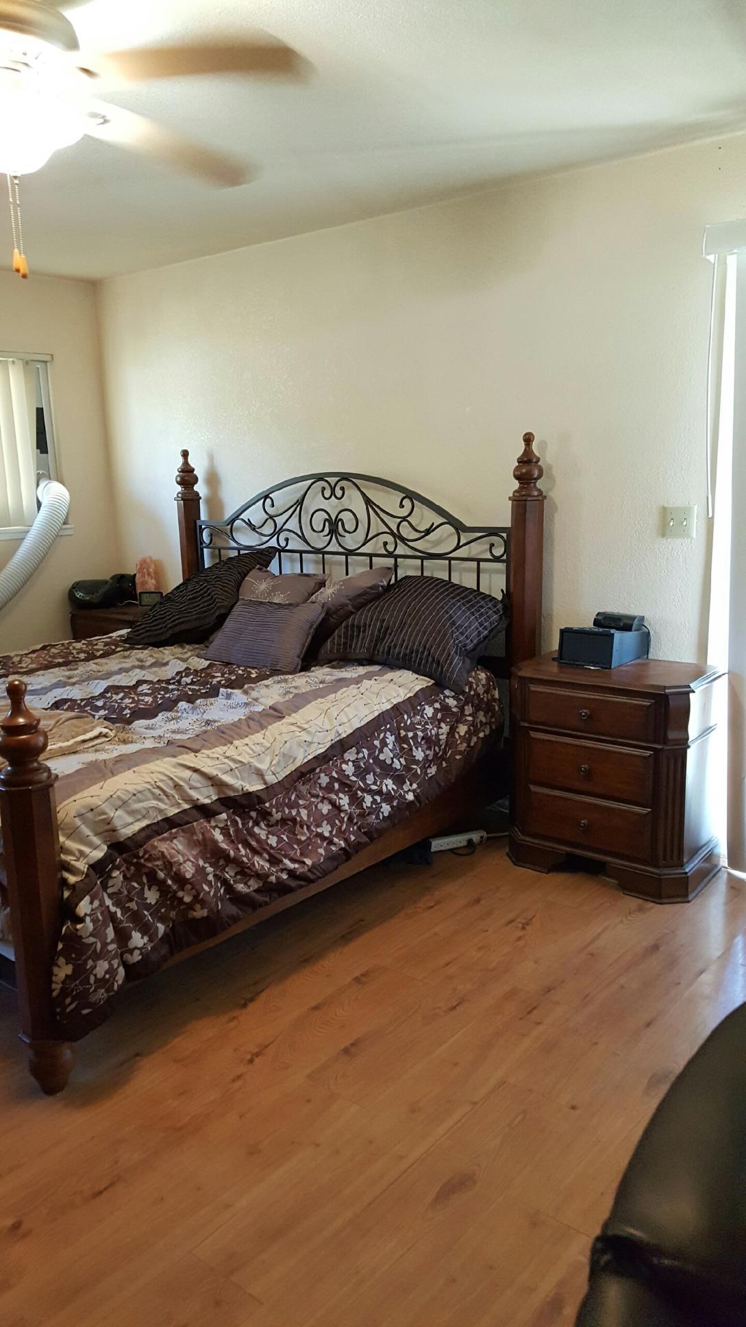 22712 Mariposa Road Tehachapi, CA 93561 - Photo 18 of 21 a bedroom with a bed and a lamp on the dresser