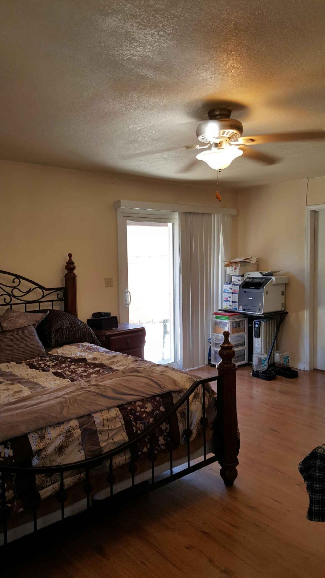 22712 Mariposa Road Tehachapi, CA 93561 - Photo 21 of 21 a bedroom with a bed and a chandelier