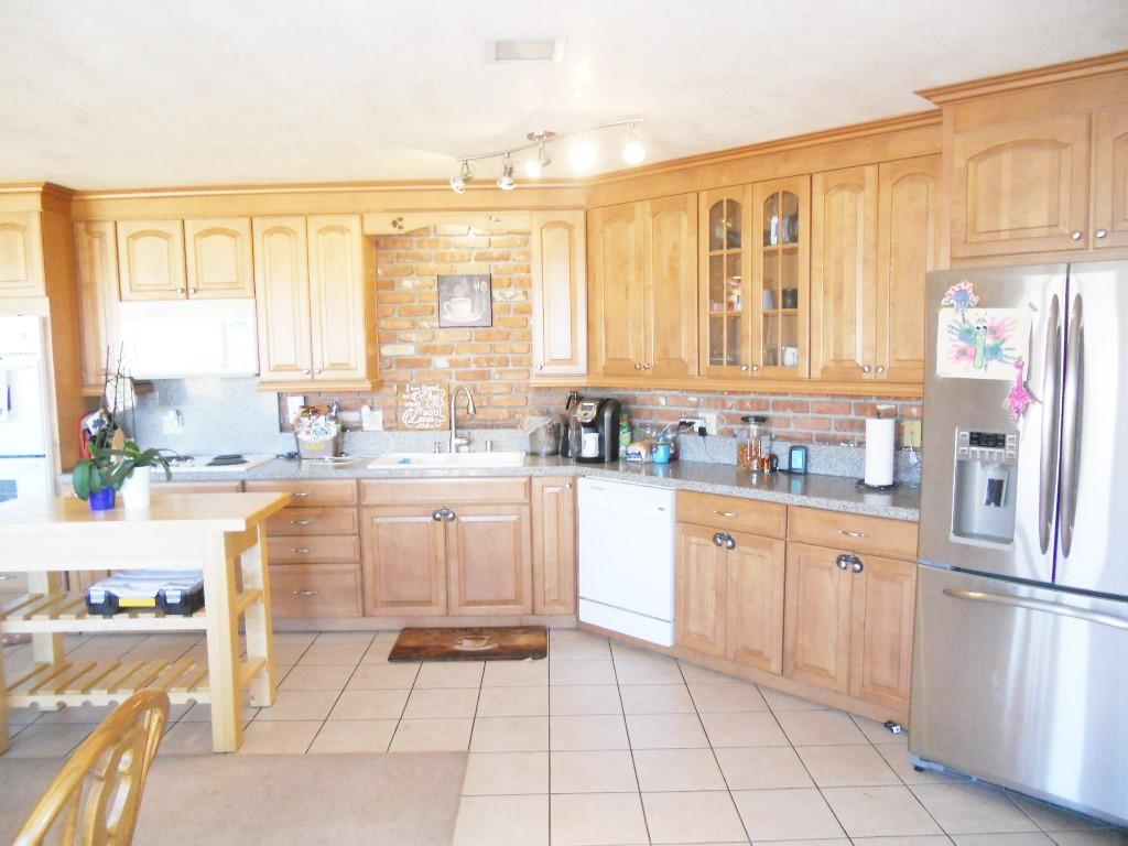 22712 Mariposa Road Tehachapi, CA 93561 - Photo 4 of 21 a kitchen with stainless steel appliances granite countertop a stove a sink and a refrigerator