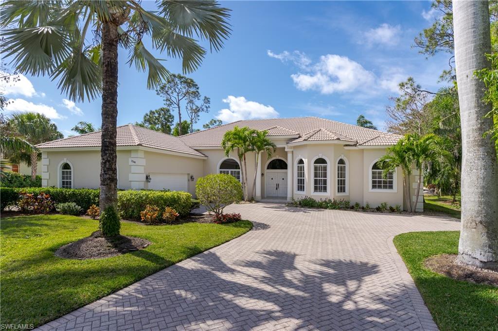 2280 Hawks Ridge Loop Naples, FL 34105 - Photo 1 of 33 Mediterranean / spanish house featuring a garage and a front yard