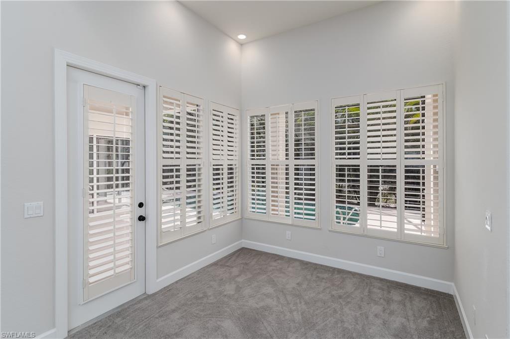 2280 Hawks Ridge Loop Naples, FL 34105 - Photo 17 of 33 Carpeted empty room with plenty of natural light