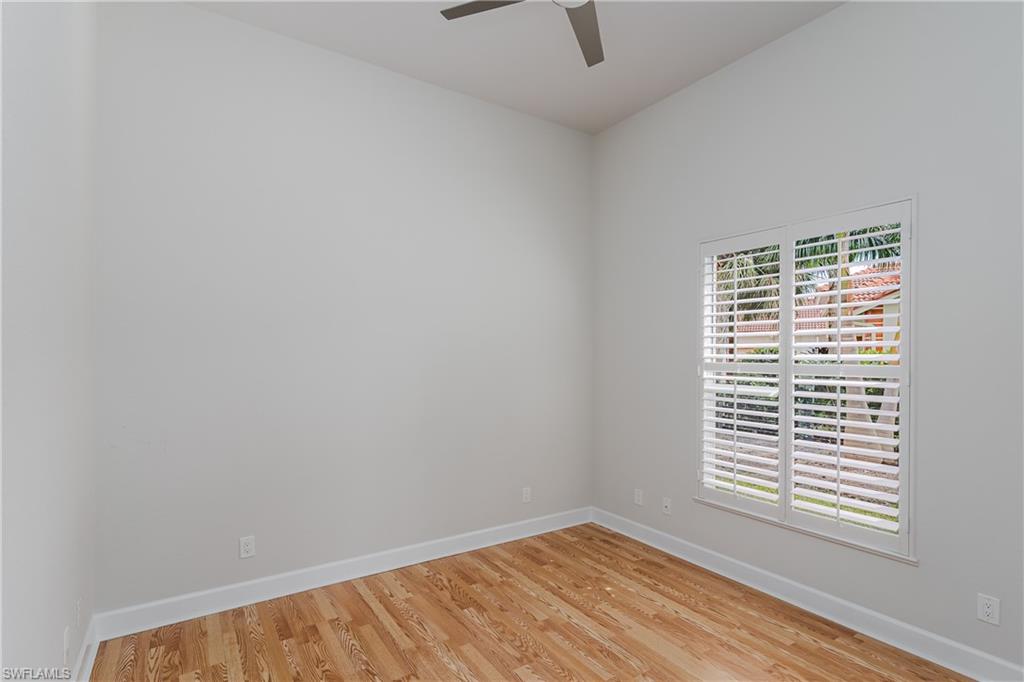 2280 Hawks Ridge Loop Naples, FL 34105 - Photo 26 of 33 Empty room featuring ceiling fan and light wood-type flooring