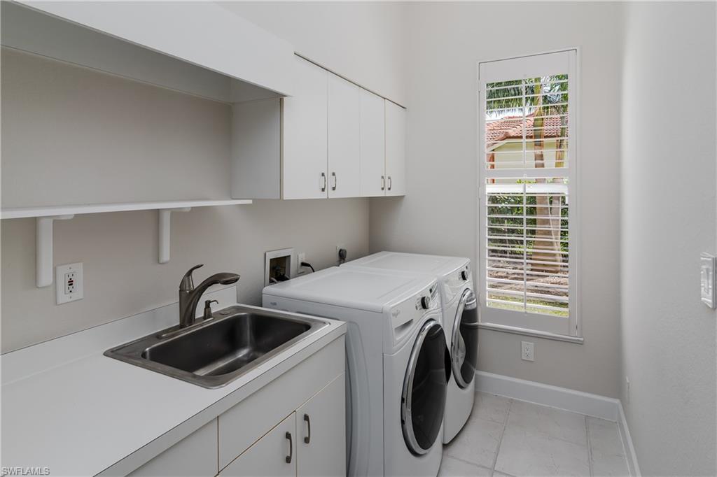2280 Hawks Ridge Loop Naples, FL 34105 - Photo 28 of 33 Washroom featuring cabinets, washing machine and dryer, sink, and light tile patterned flooring