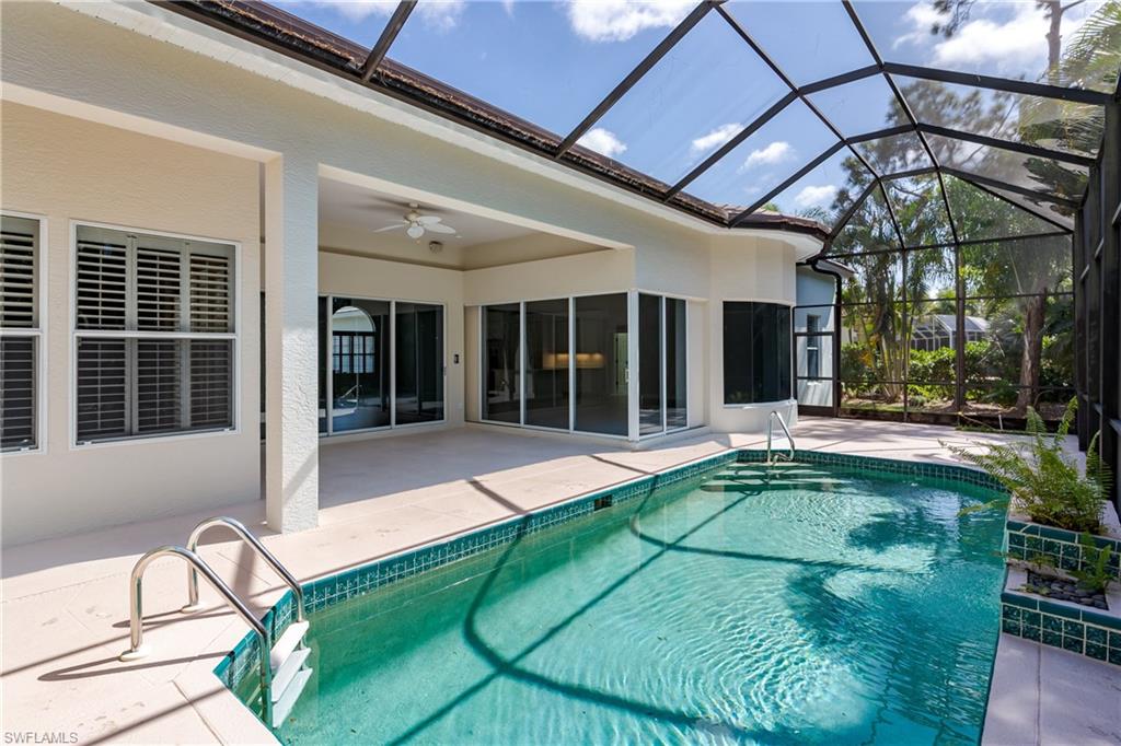 2280 Hawks Ridge Loop Naples, FL 34105 - Photo 29 of 33 View of swimming pool with a lanai, ceiling fan, and a patio area