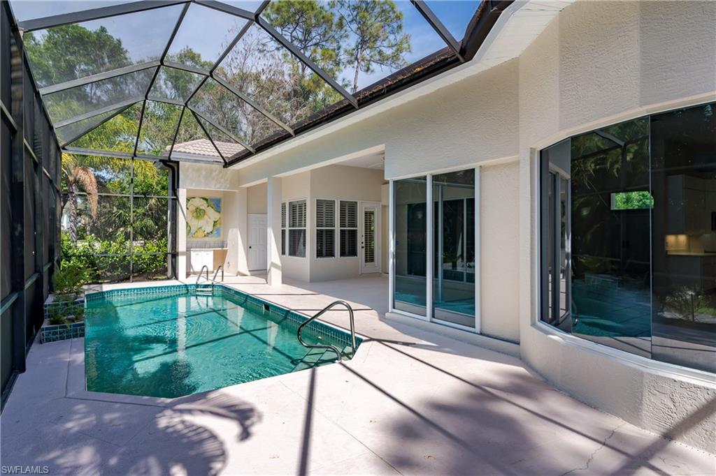 2280 Hawks Ridge Loop Naples, FL 34105 - Photo 30 of 33 View of swimming pool featuring a lanai and a patio area
