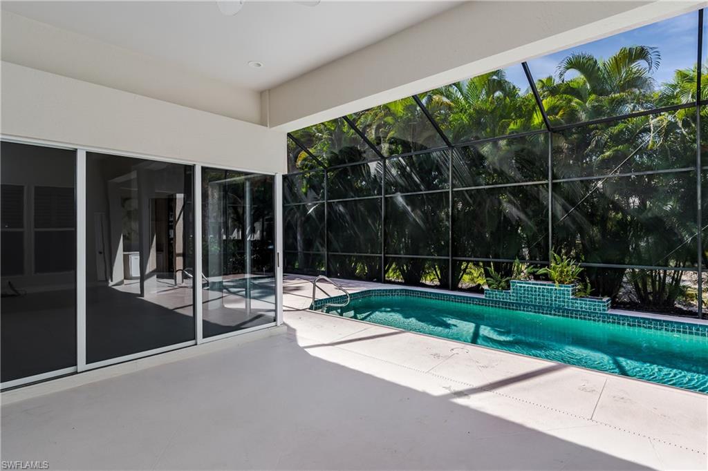 2280 Hawks Ridge Loop Naples, FL 34105 - Photo 31 of 33 View of swimming pool with a patio area