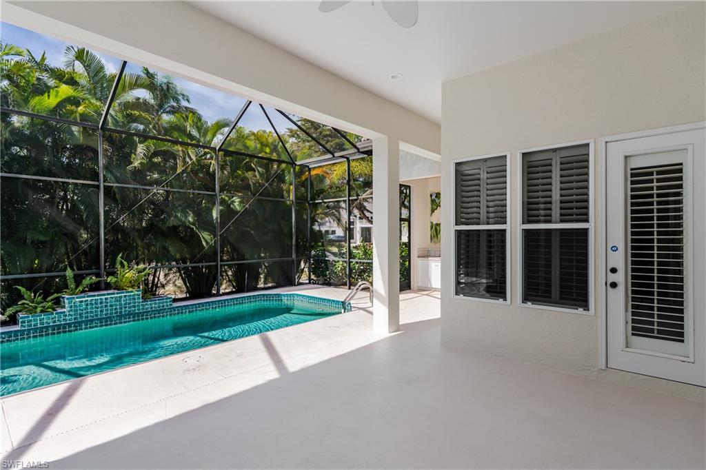 2280 Hawks Ridge Loop Naples, FL 34105 - Photo 32 of 33 View of swimming pool featuring a patio and glass enclosure