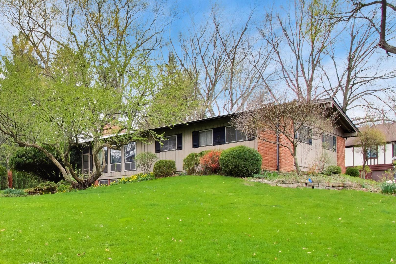 1056 Van Tassel Road Sleepy Hollow, IL 60118 - Photo 2 of 34 a view of a house with a big yard and large tree