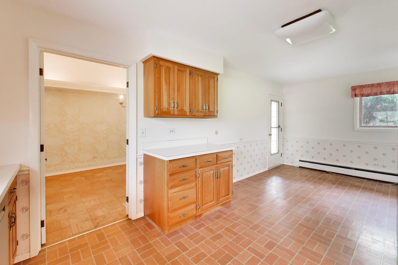 1056 Van Tassel Road Sleepy Hollow, IL 60118 - Photo 10 of 34 a view of a kitchen with wooden floor and cabinets