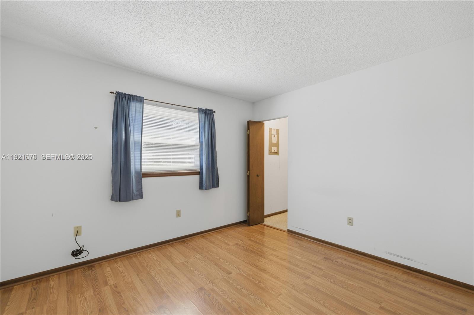 9230 Southwest 101st Place Ocala, FL 34481 - Photo 13 of 30 a view of an empty room with wooden floor and a window