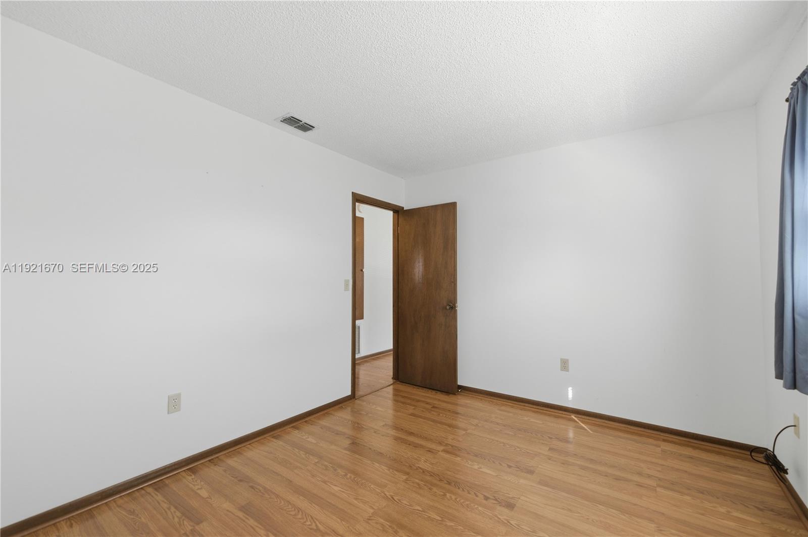 9230 Southwest 101st Place Ocala, FL 34481 - Photo 14 of 30 a view of an empty room with wooden floor and closet