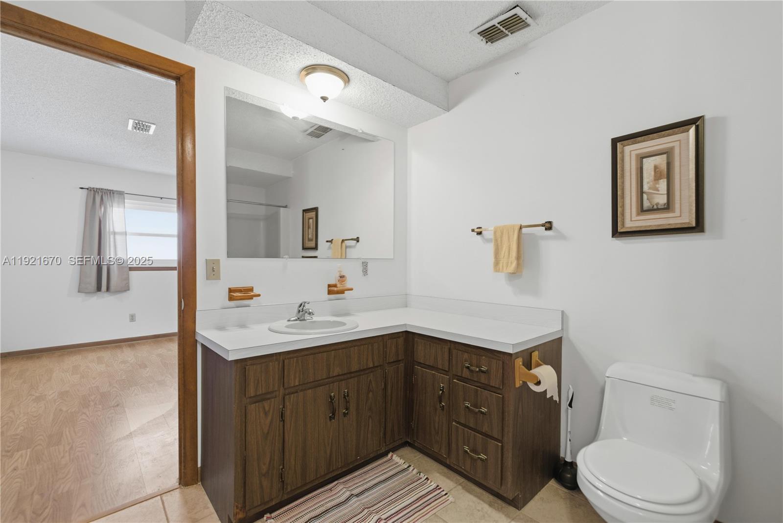 9230 Southwest 101st Place Ocala, FL 34481 - Photo 15 of 30 a spacious bathroom with a toilet sink a mirror and vanity