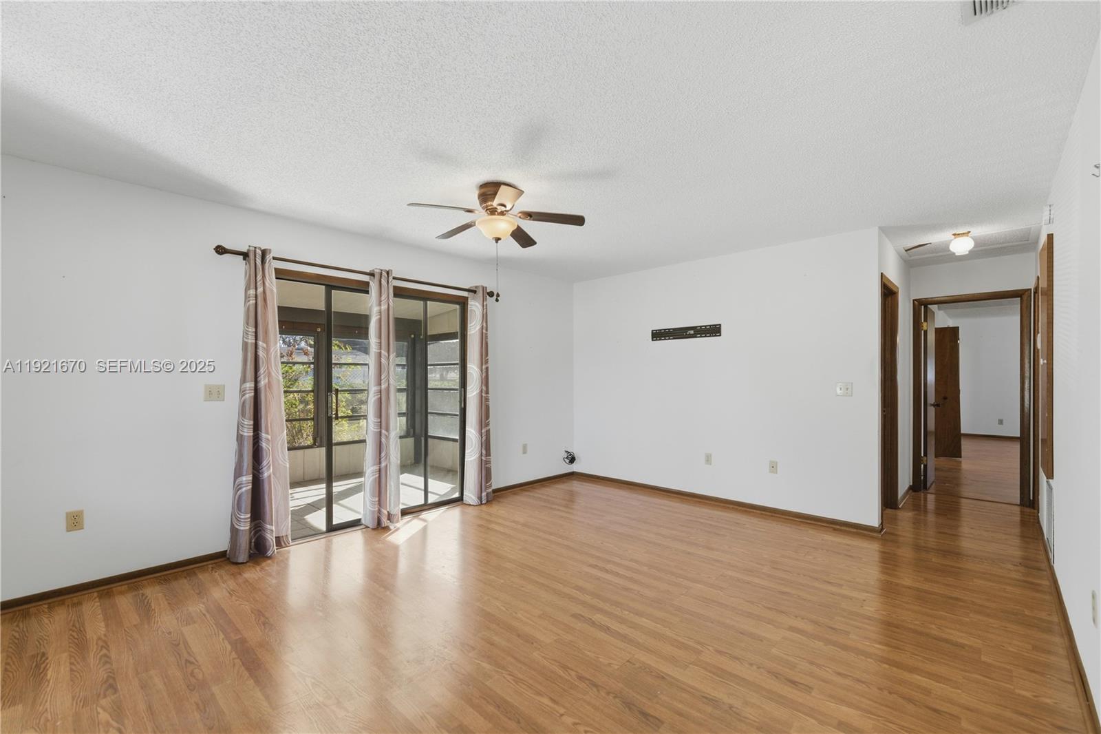 9230 Southwest 101st Place Ocala, FL 34481 - Photo 3 of 30 a view of an empty room with wooden floor