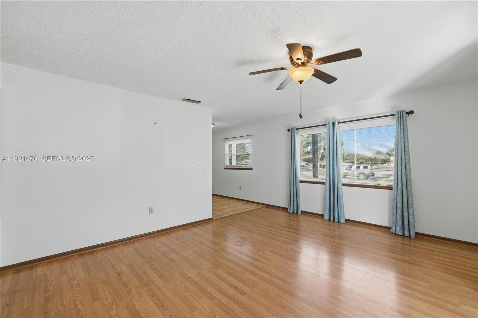 9230 Southwest 101st Place Ocala, FL 34481 - Photo 4 of 30 a view of an empty room with window and wooden floor
