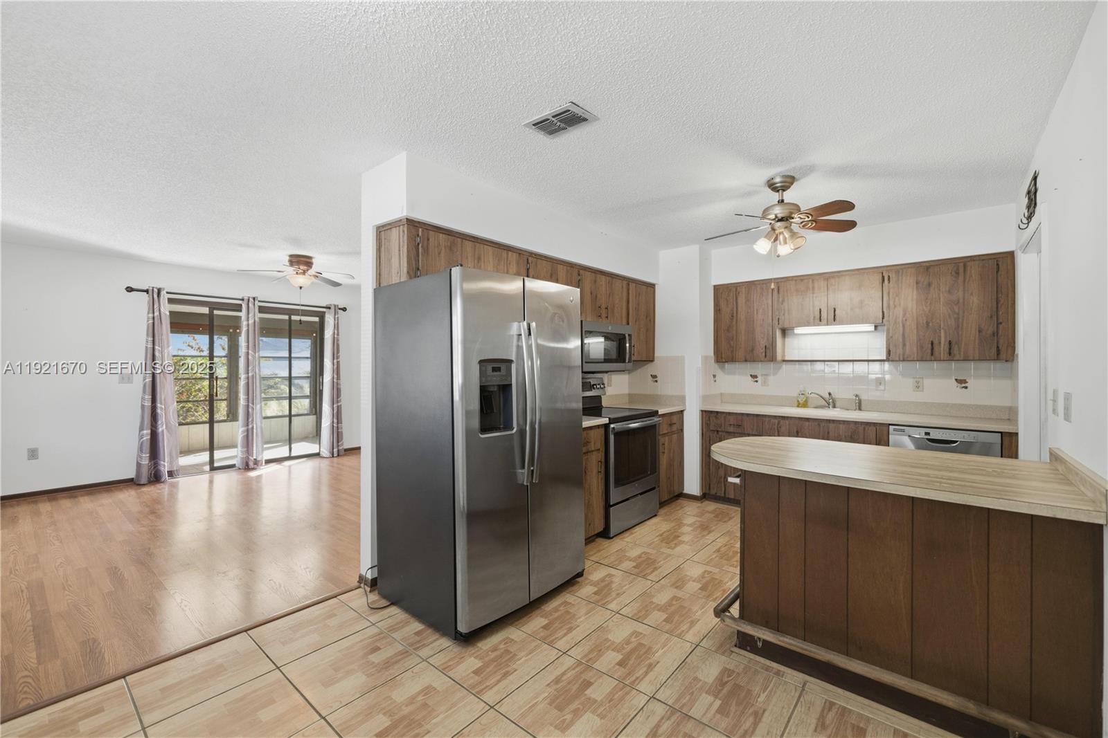 9230 Southwest 101st Place Ocala, FL 34481 - Photo 6 of 30 a kitchen with stainless steel appliances granite countertop a refrigerator a oven a sink and dishwasher