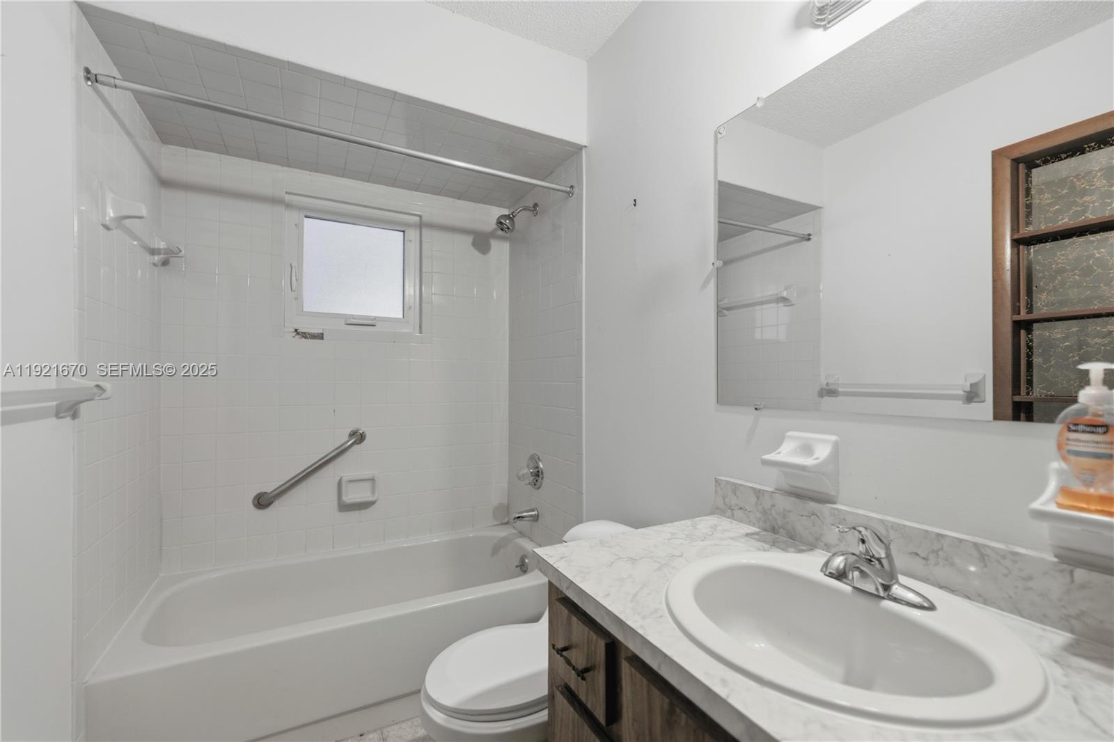 9230 Southwest 101st Place Ocala, FL 34481 - Photo 10 of 30 a bathroom with a bathtub shower sink vanity mirror and toilet