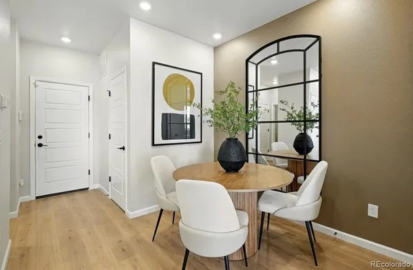 a kitchen with stainless steel appliances granite countertop a refrigerator sink and white cabinets