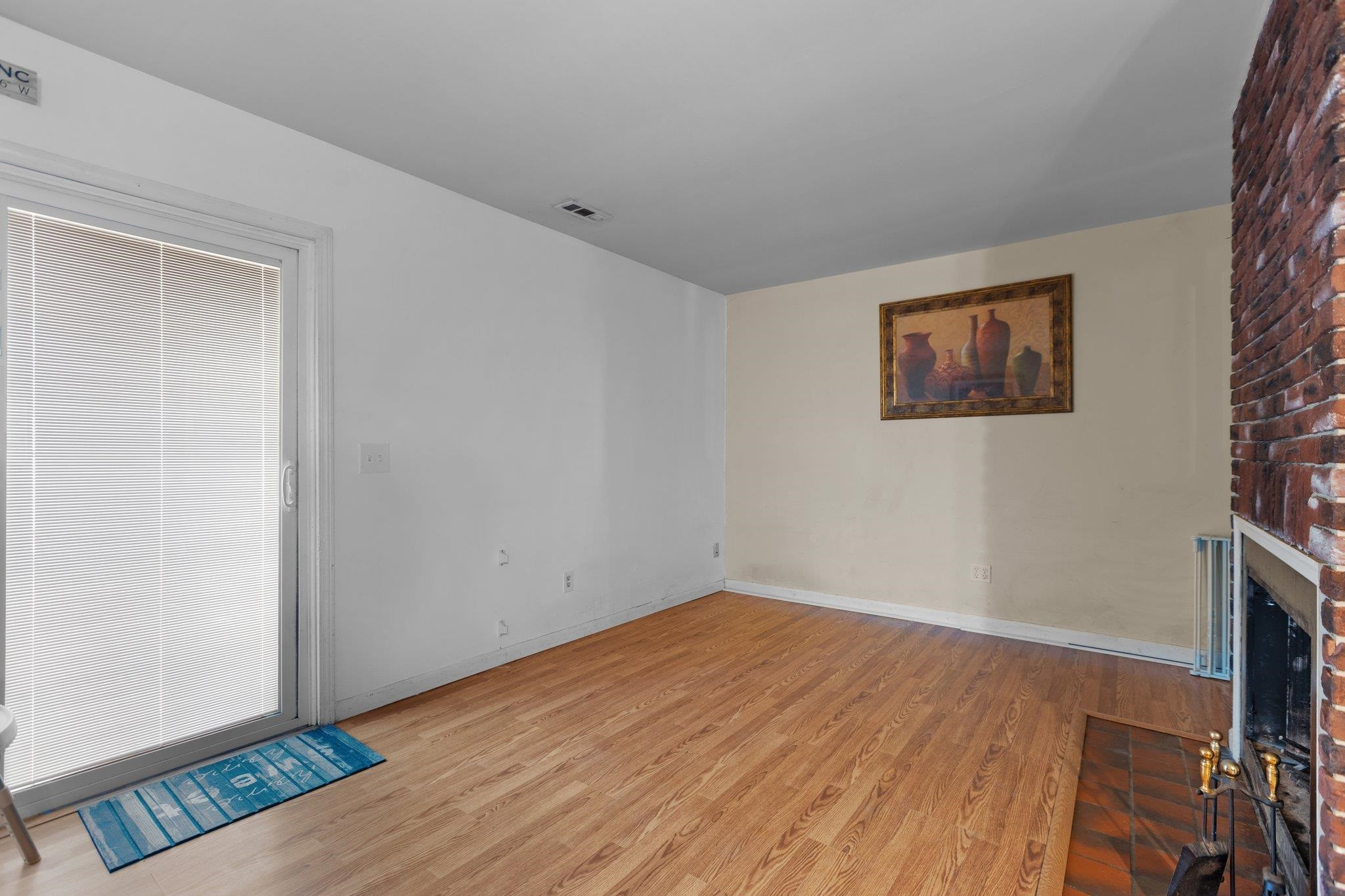 1227 Seaton Road, Unit 34 Durham, NC 27713 - Photo 12 of 32 a view of an empty room with wooden floor
