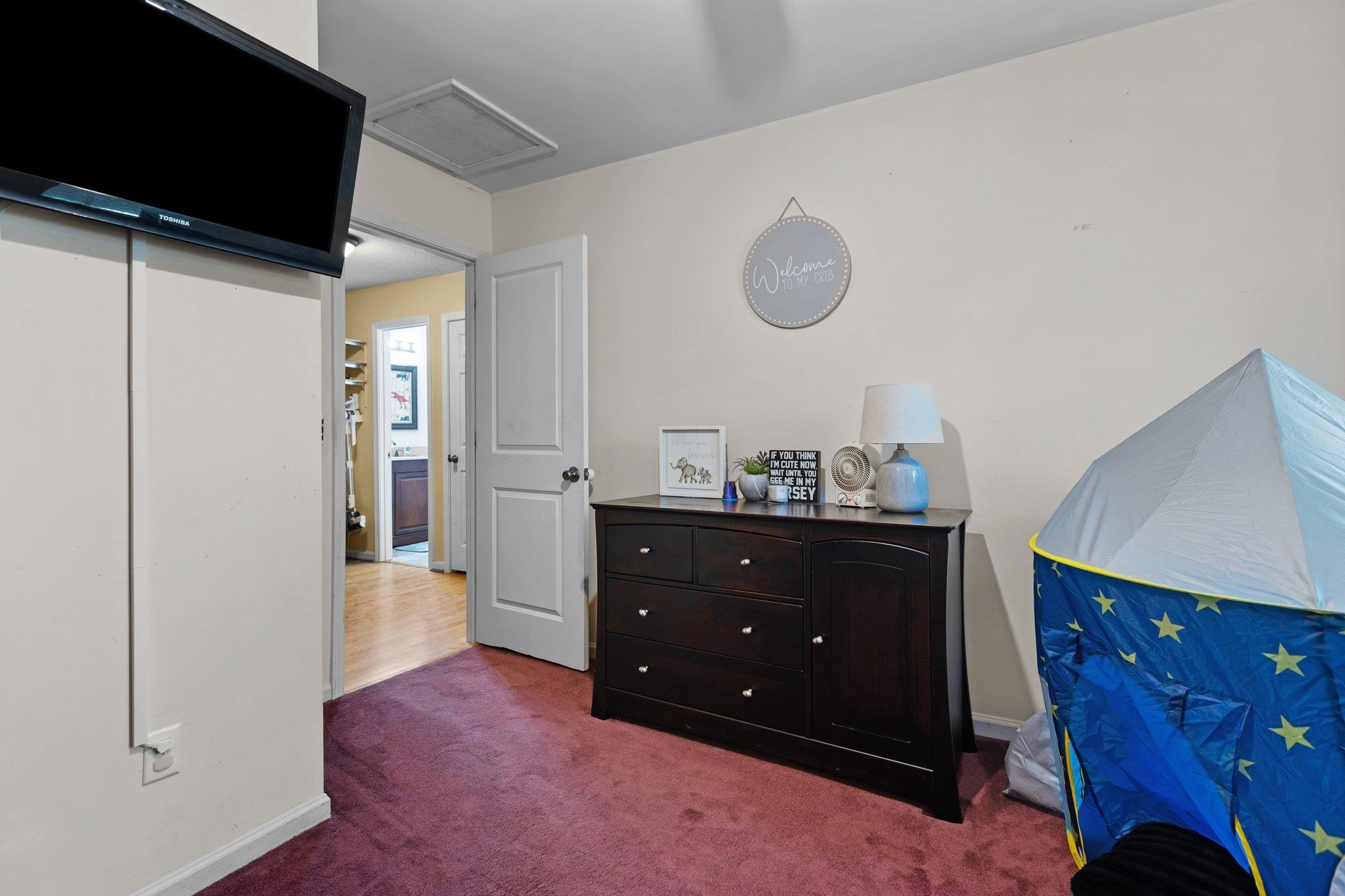 1227 Seaton Road, Unit 34 Durham, NC 27713 - Photo 23 of 32 a room with a dresser and a mirror