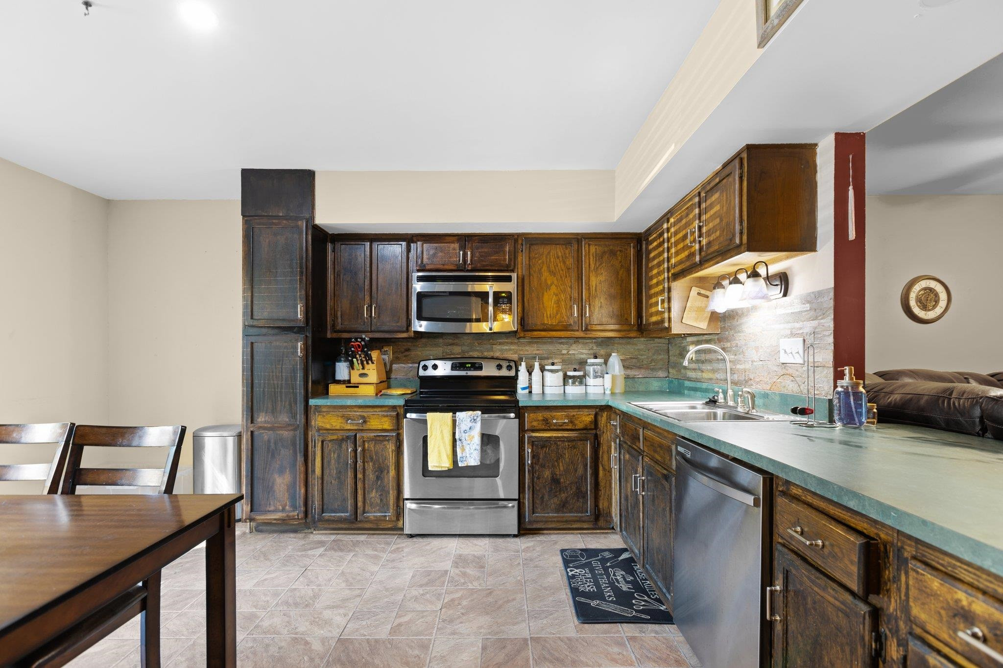 1227 Seaton Road, Unit 34 Durham, NC 27713 - Photo 4 of 32 a kitchen with stainless steel appliances granite countertop a sink stove and refrigerator