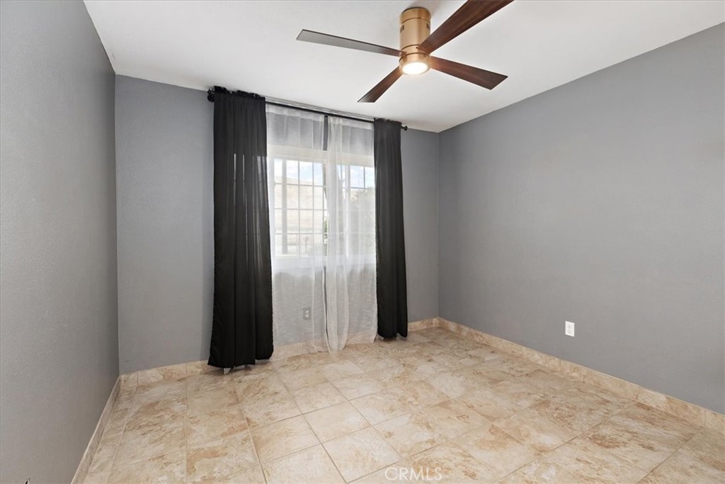 2914 West Wilson Street Banning, CA 92220 - Photo 14 of 31 an empty room with closet and a ceiling fan