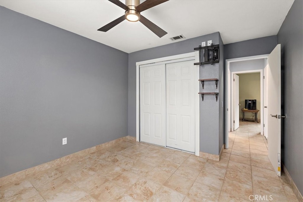 2914 West Wilson Street Banning, CA 92220 - Photo 15 of 31 en empty room with closet and a chandelier fan