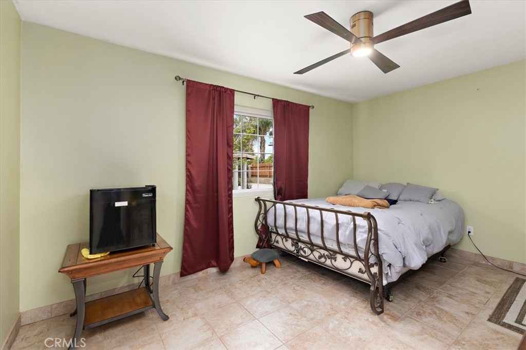 2914 West Wilson Street Banning, CA 92220 - Photo 18 of 31 a bed sitting in a spacious bedroom next to a window