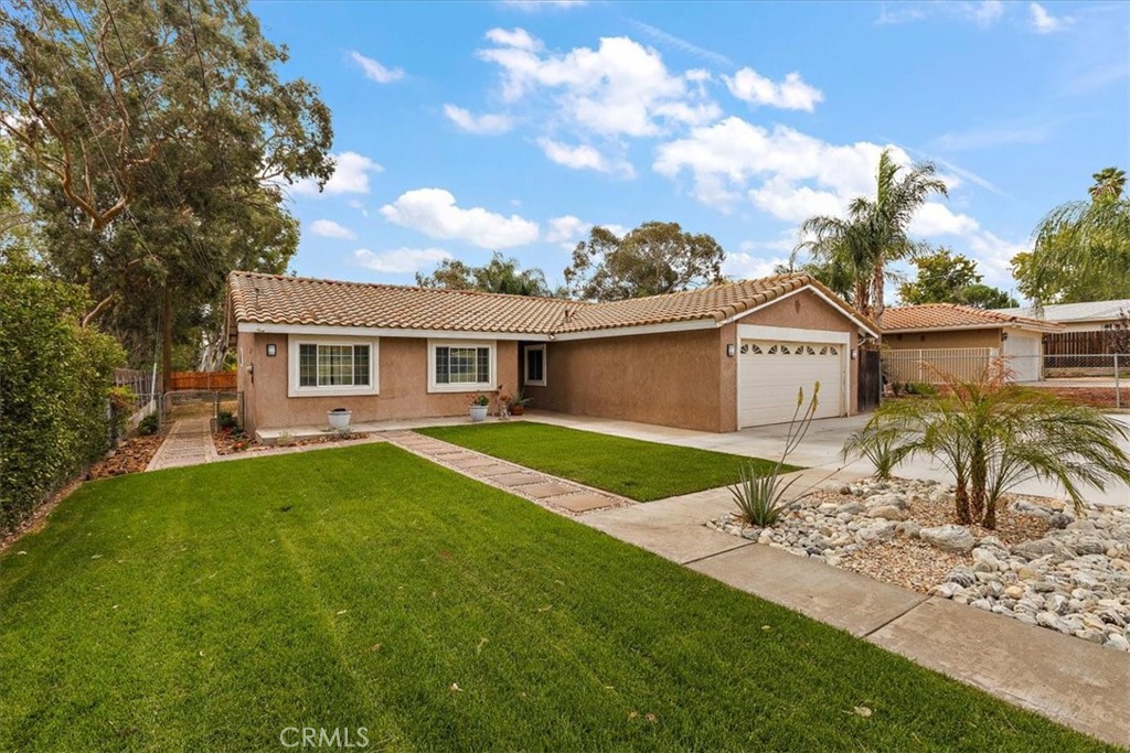 2914 West Wilson Street Banning, CA 92220 - Photo 22 of 31 a front view of a house with a garden