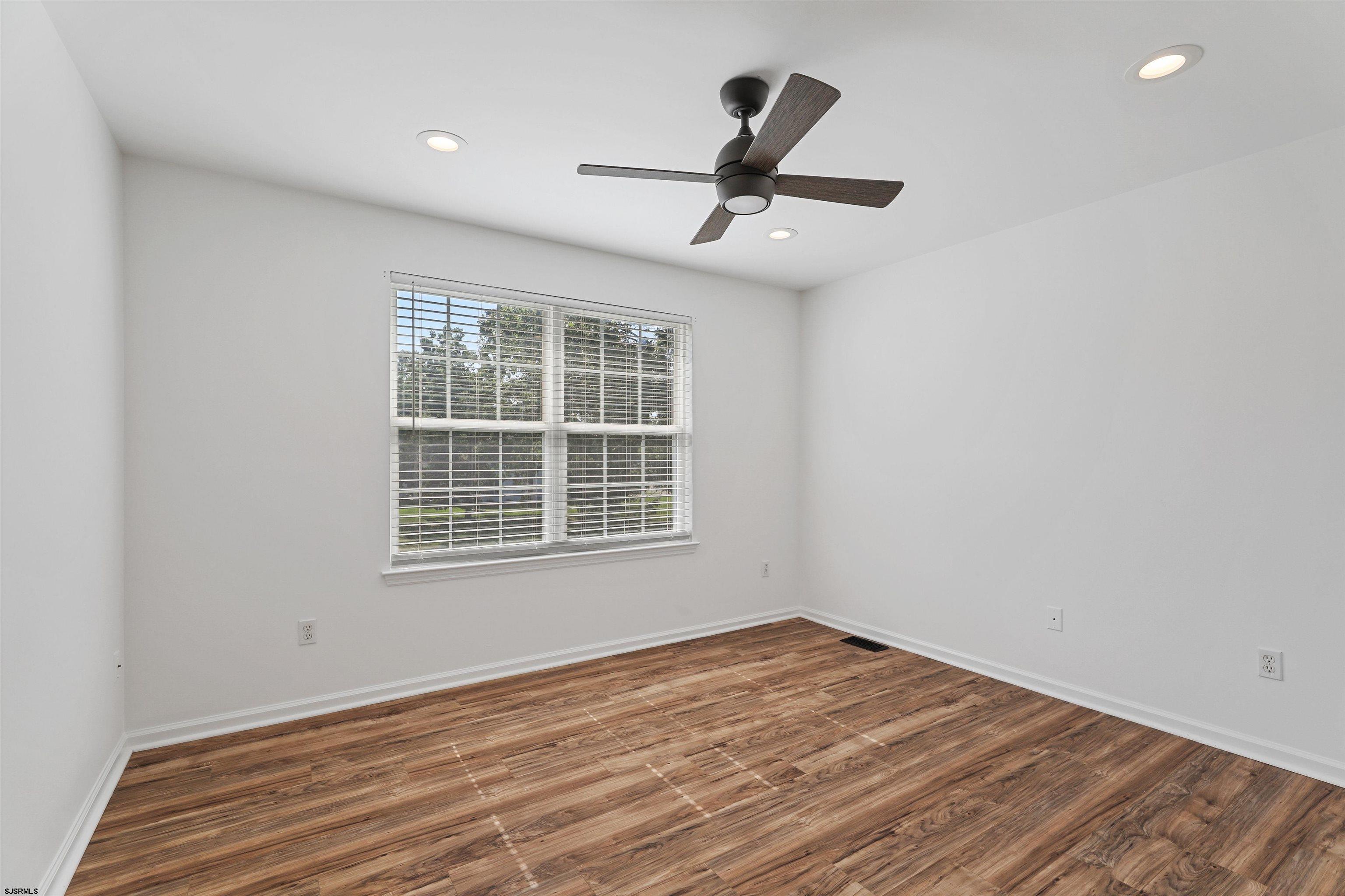 34 Kay Drive Hammonton, NJ 08037 - Photo 13 of 23 an empty room with a window and a ceiling fan