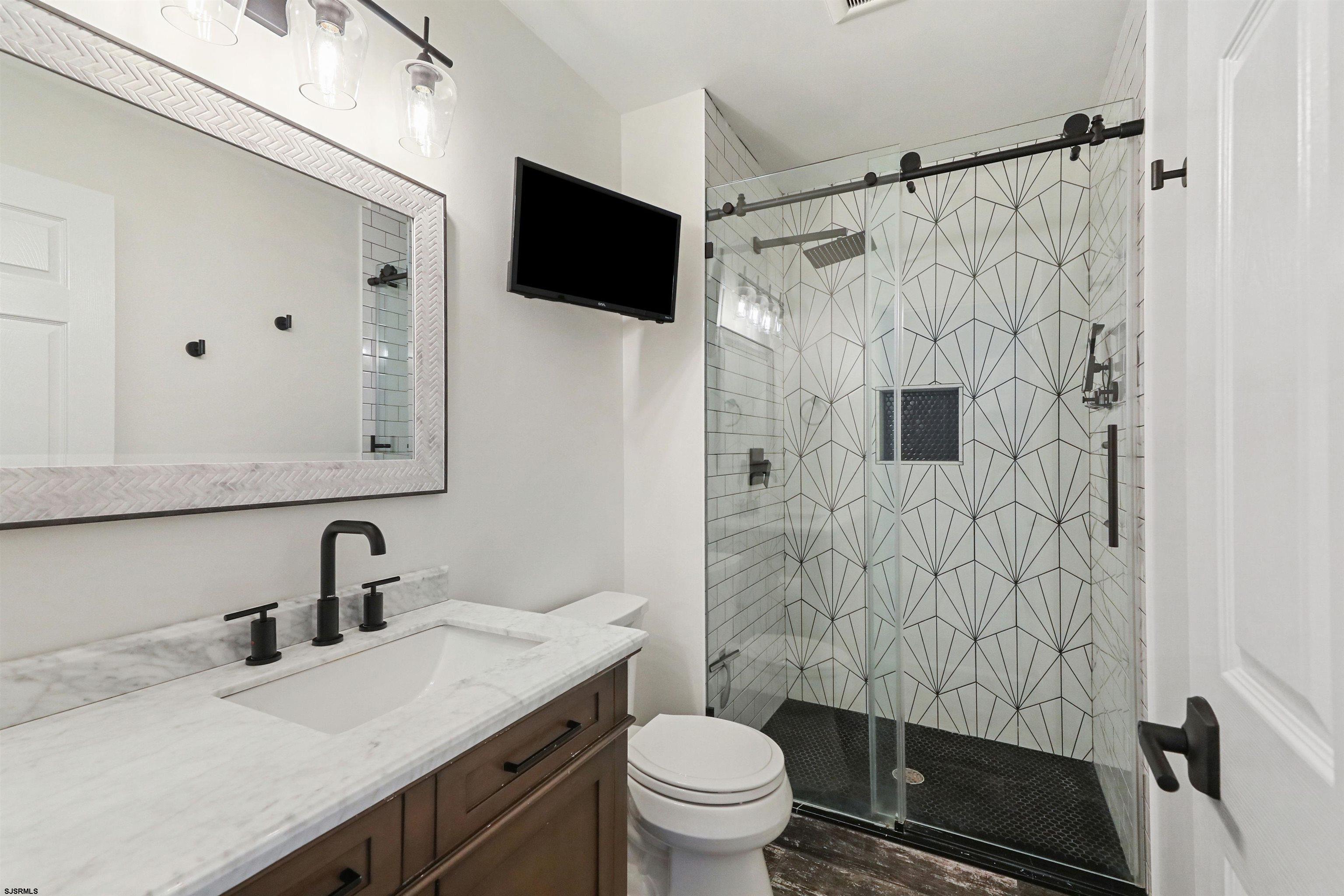 34 Kay Drive Hammonton, NJ 08037 - Photo 17 of 23 a bathroom with a sink toilet a mirror and shower curtain