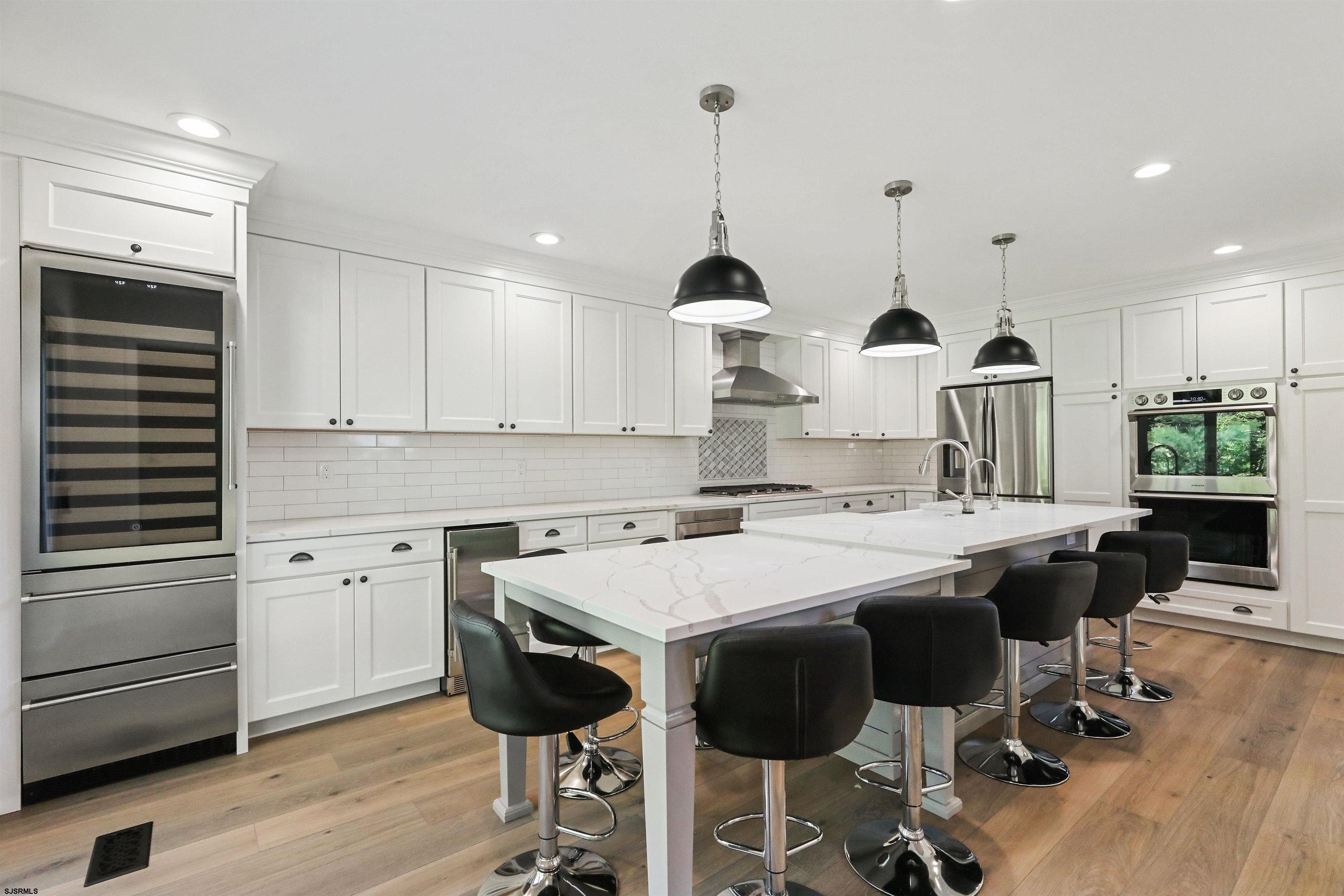 34 Kay Drive Hammonton, NJ 08037 - Photo 5 of 23 a kitchen with stainless steel appliances kitchen island granite countertop a table chairs sink and cabinets