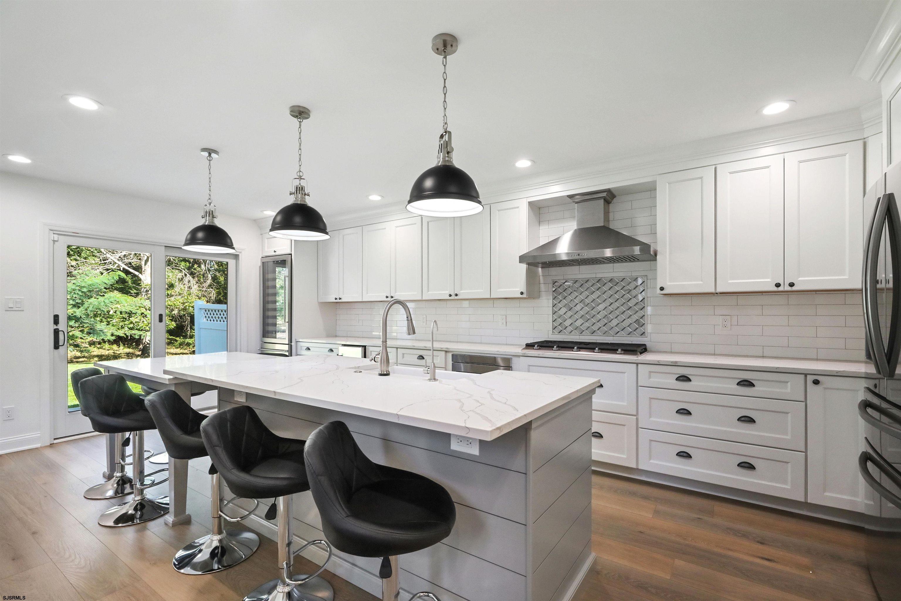 34 Kay Drive Hammonton, NJ 08037 - Photo 6 of 23 a kitchen with a stove a sink a dining table and chairs