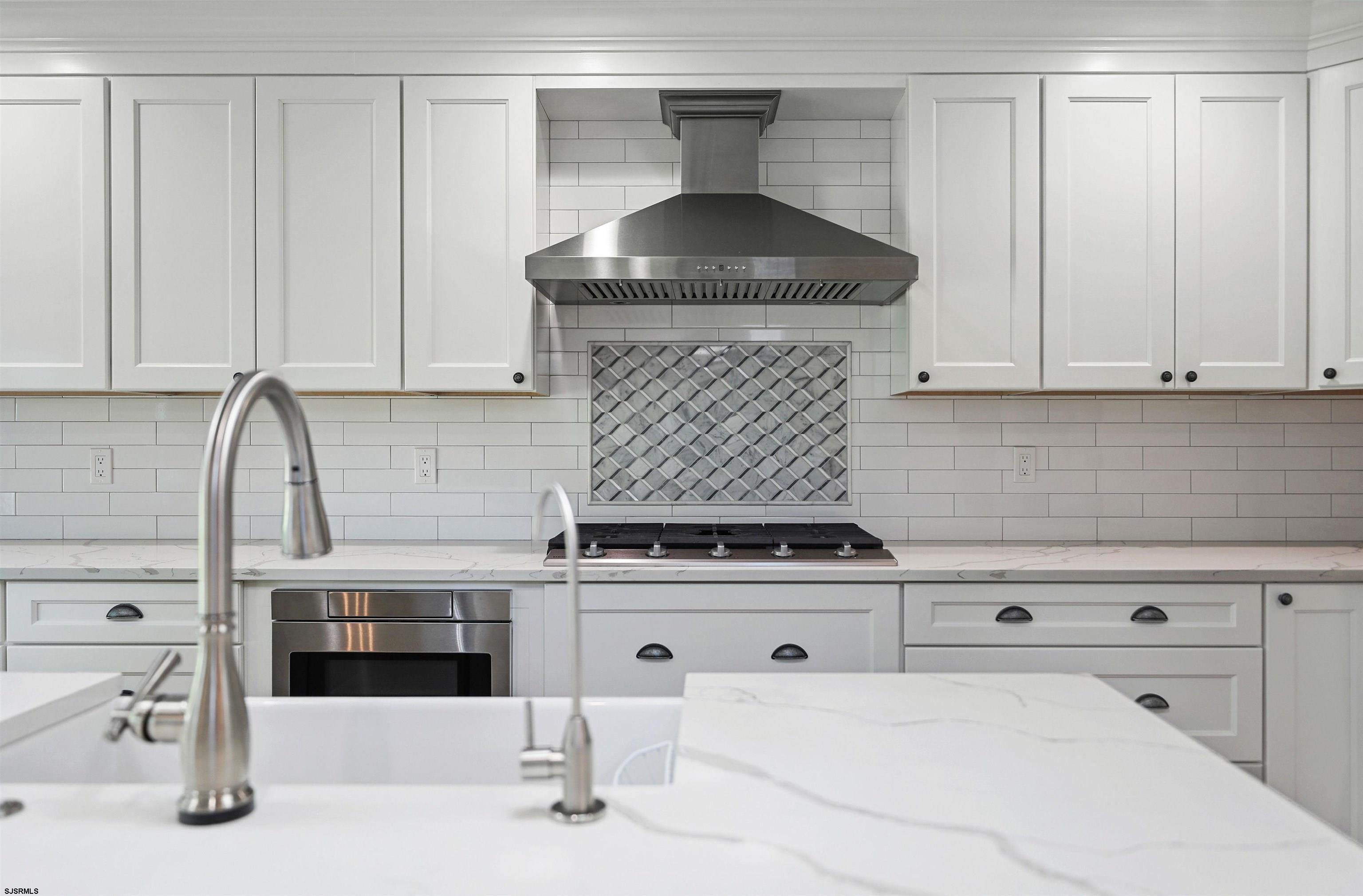 34 Kay Drive Hammonton, NJ 08037 - Photo 10 of 23 a kitchen with granite countertop a stove and white cabinets