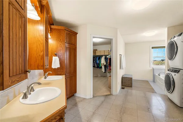 a en suite bathroom with a sink double vanity and a mirror