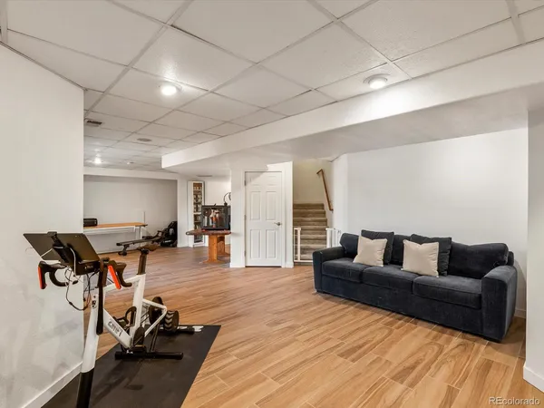 a living room with furniture and a wooden floor