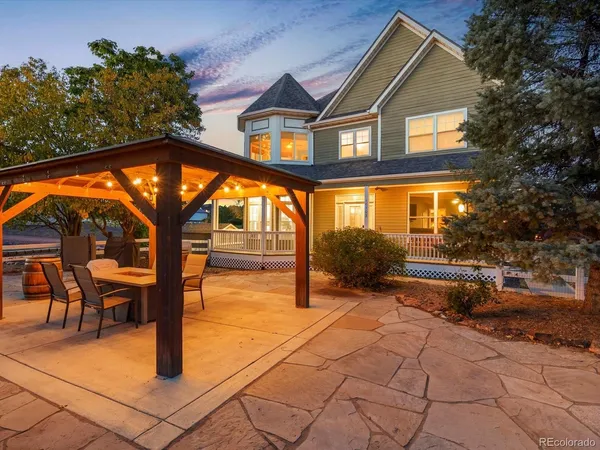 a view of house with yard and sitting area