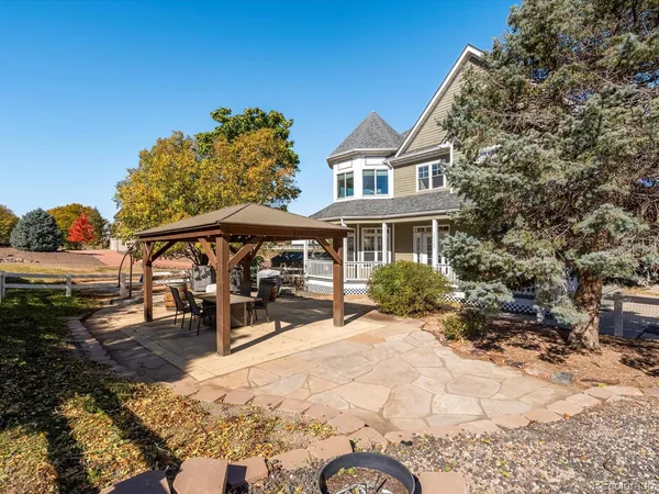 a view of a house with backyard porch and sitting area